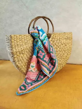 Handwoven Grass Bag with Vibrant Scarf Accent