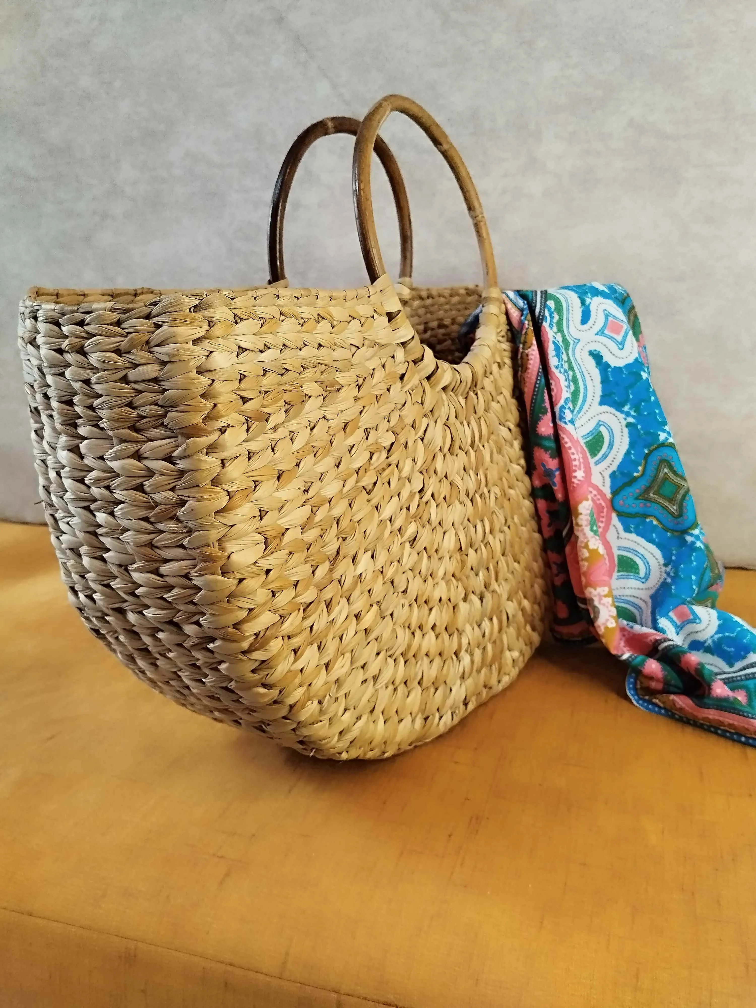 Handwoven Grass Bag with Vibrant Scarf Accent